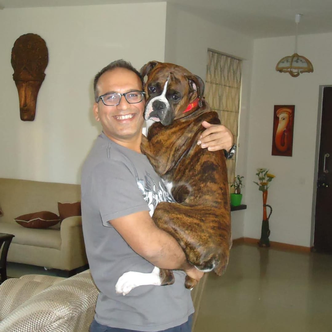 A father holding Brutus — the bond that built JJW