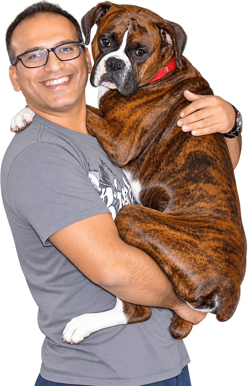 JJW's founder holding Brutus, the family boxer whose bond started the universe